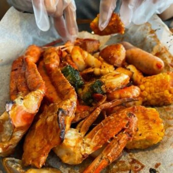 A close-up of cooked crab legs and corn on the cob. 3