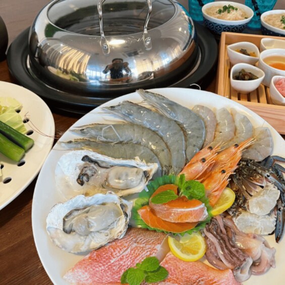 A seafood platter with various types of fish, shrimp, and garnishes. 4