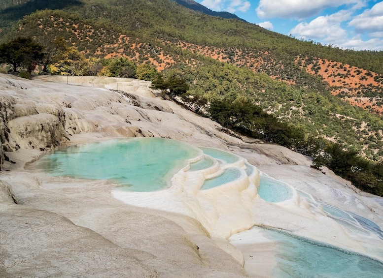 Terraced mineral pools in a mountainous landscape. 5
