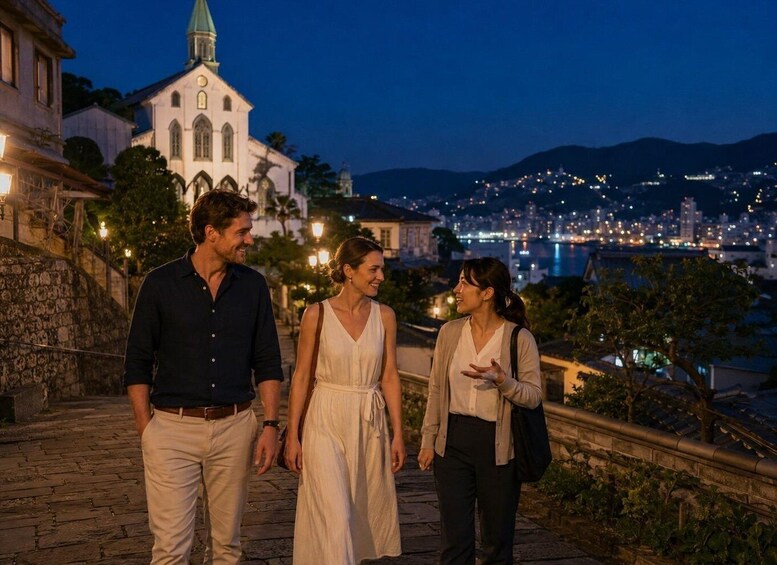 A group of people walking on a stone pathway at dusk with a cityscape and a church in the background. 4