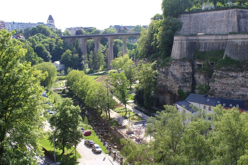 A bridge, trees, a river, and buildings. 3