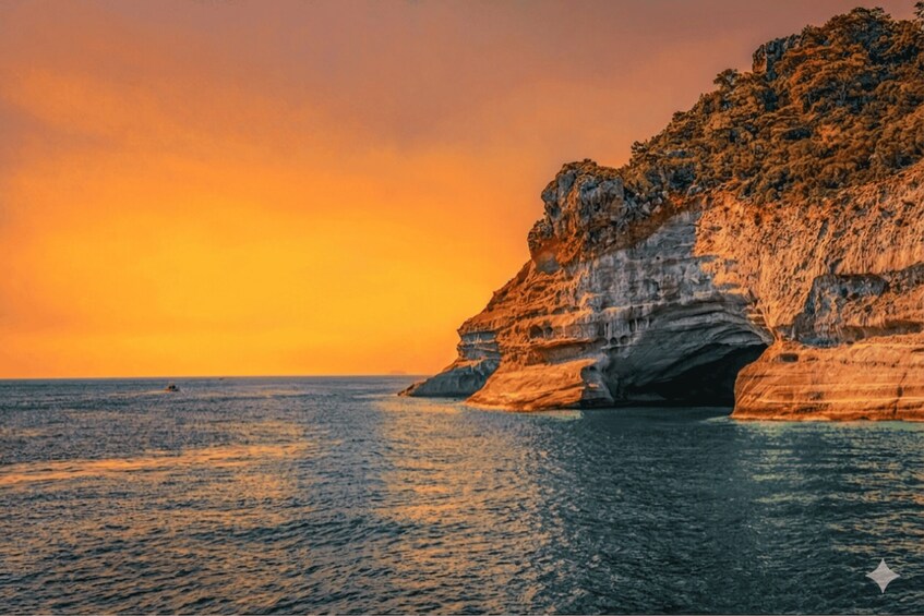 A coastal landscape with a cliff and a calm sea during sunset. 3
