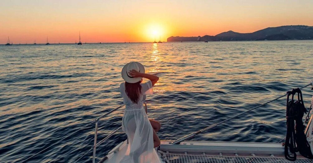A person on a boat at sunset with the sun reflecting on the water. 2