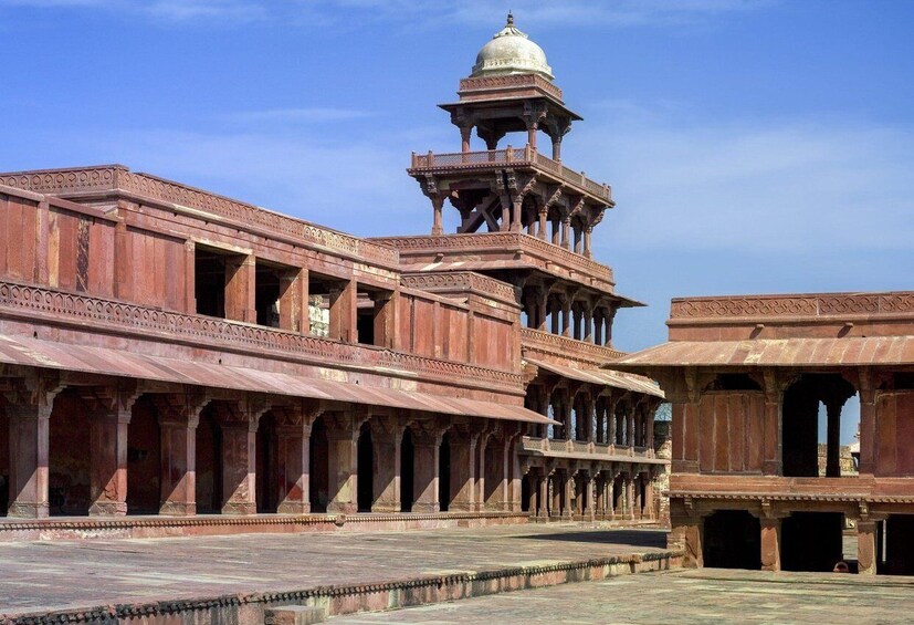A historic building with intricate arches and a central dome. 3