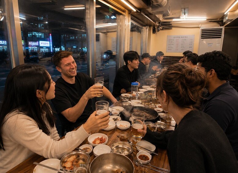 A group of people dining at a restaurant with a view of the city at night. 5