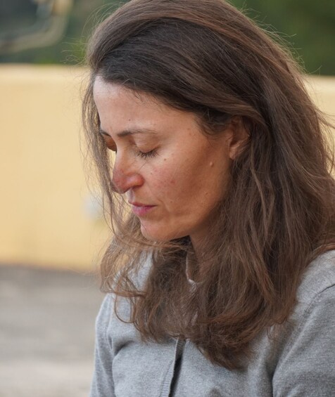 A person with long hair wearing a grey top. 2