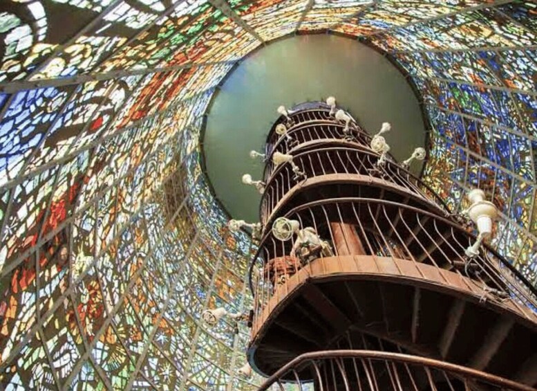 A spiral staircase with a stained glass dome ceiling. 2