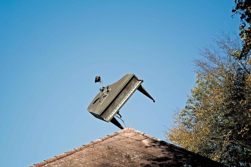 A satellite dish on a roof with a clear blue sky in the background. 5