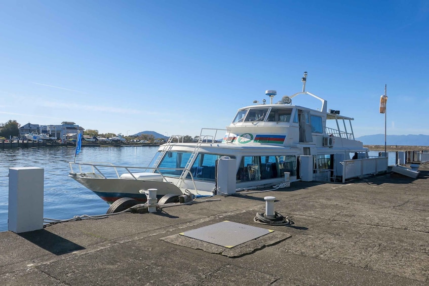 A white boat docked at a pier with a clear blue sky in the background. 3