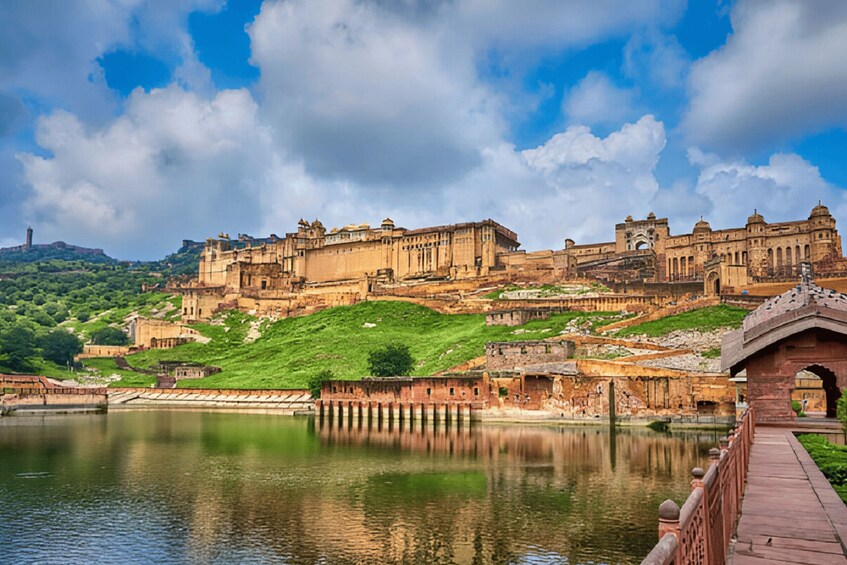 A historic fort with a river in the foreground and a clear sky. 1