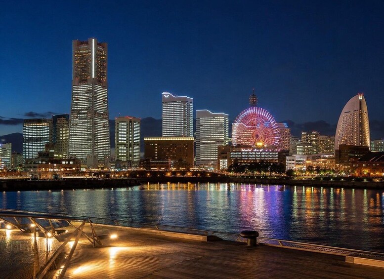 A city skyline at night with illuminated buildings and a Ferris wheel reflecting on the water. 4