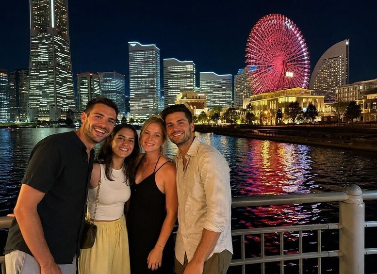 A group of people posing in front of a city skyline with a prominent Ferris wheel. 5