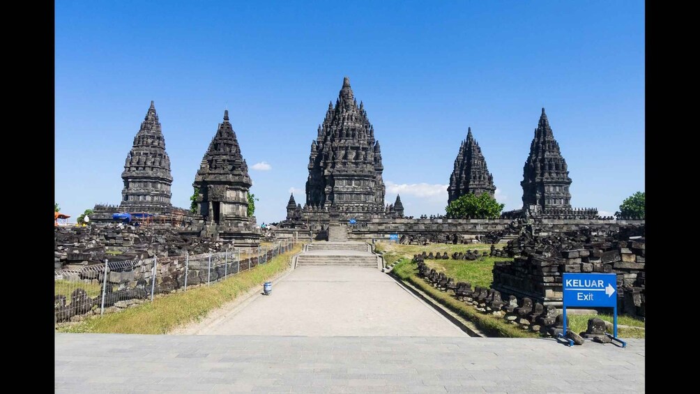 A temple complex with multiple tiered towers and a clear sky. 4