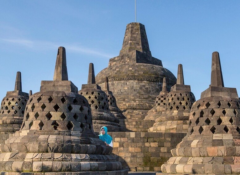 A large stone structure with multiple domed roofs and a central tower. 4