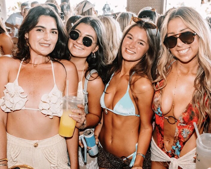 A group of people in swimwear at a beachside event. 5