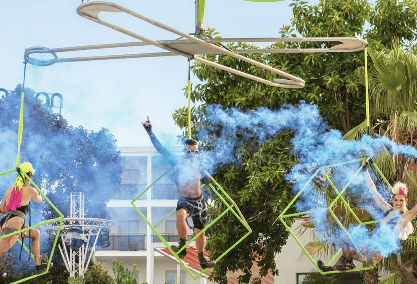 People engaged in an outdoor activity involving ropes and smoke effects. 3