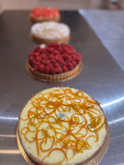 A dessert display with various toppings on a metal surface. 4
