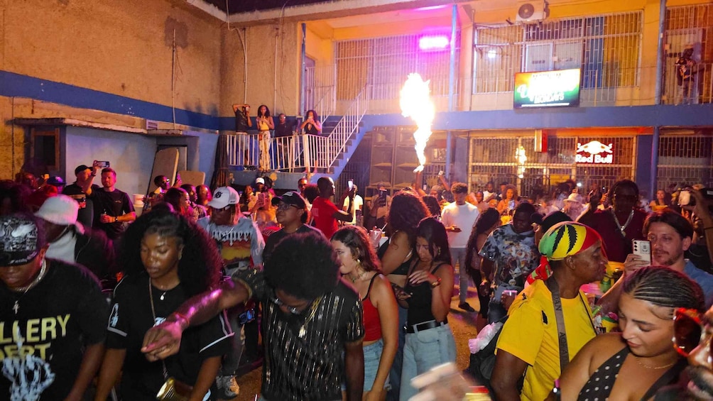 A crowded indoor event with people standing and socializing. 5