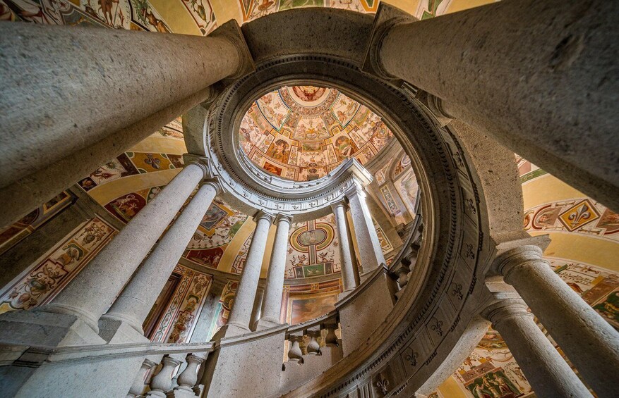 A grand architectural interior with a domed ceiling and ornate columns. 1