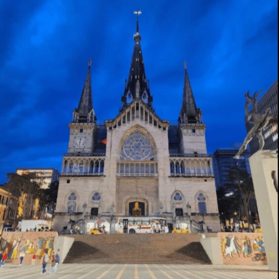 A large cathedral with two spires and a central rose window. 1