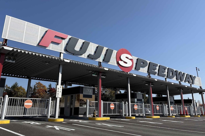 A FUJISPEEDWAY toll booth with barriers and a clear blue sky. 2