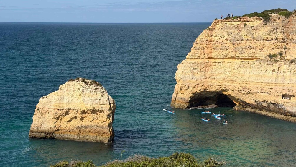A coastal landscape with cliffs and a clear blue sea. 2
