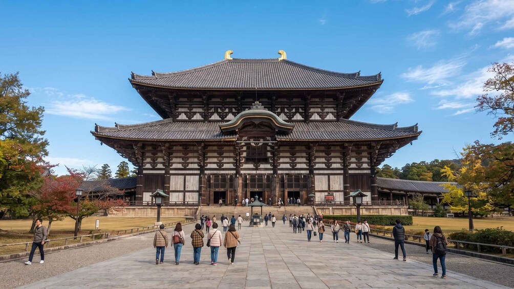 A traditional Japanese building with a multi-tiered roof, surrounded by visitors. 5