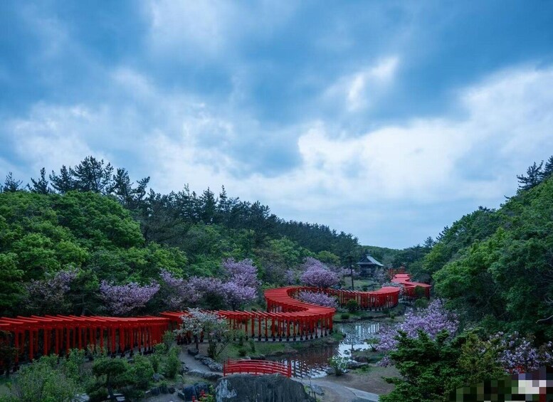 A serene Japanese garden with red torii gates, a pond, and lush greenery. 3