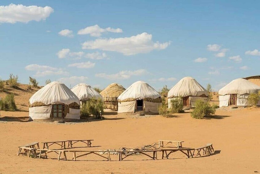 Yurts in a desert landscape with a clear sky. 2