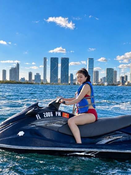 A person on a jet ski with a city skyline in the background. 3