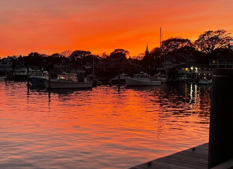 A marina at sunset with boats docked and buildings in the background. 5