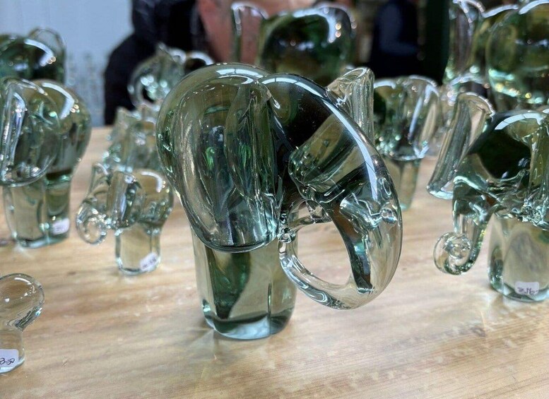 A collection of glass elephant sculptures on display. 4