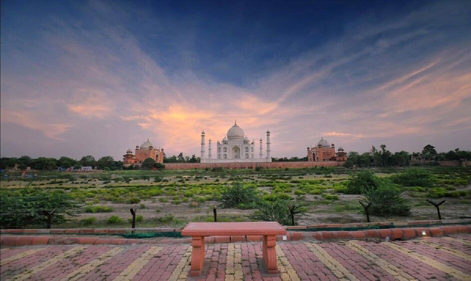 The Taj Mahal with a bench in the foreground. 4