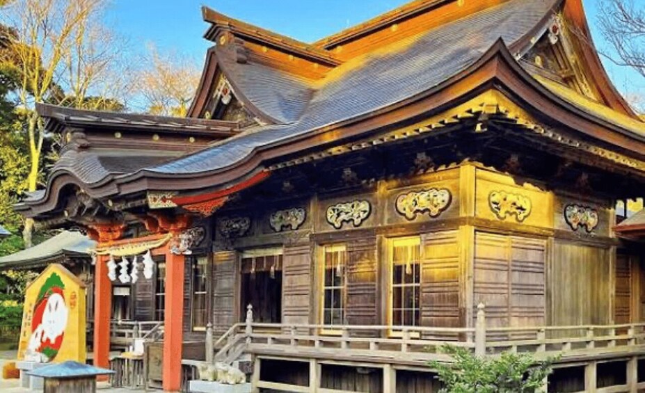 A traditional wooden building with ornate roof details and a small porch. 2