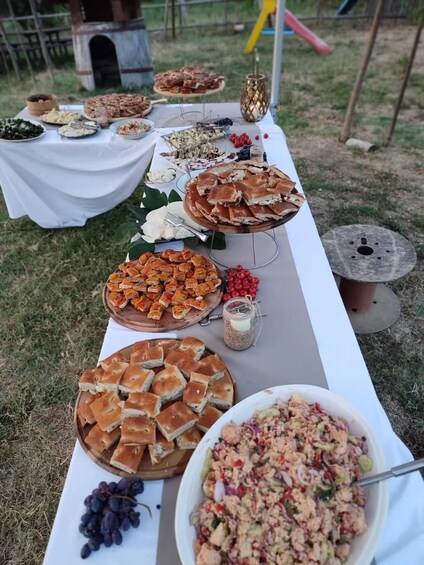 An outdoor buffet with various dishes and a decorative lantern. 5