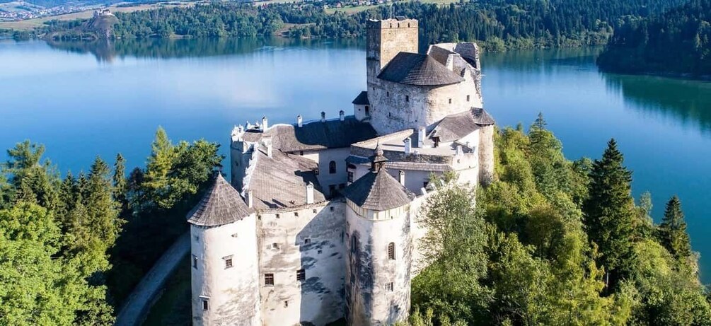 A castle surrounded by a lake and forest. 5