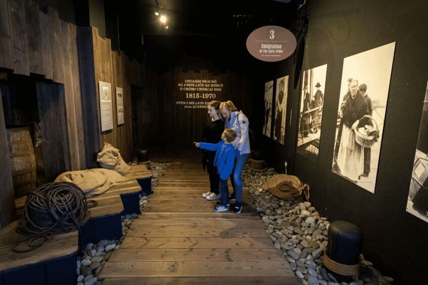 An indoor exhibit with historical photographs and wooden panels. 2