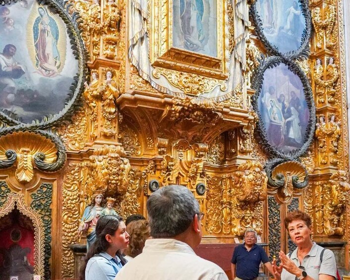 Ornate religious architecture with golden decorations and religious paintings. 4