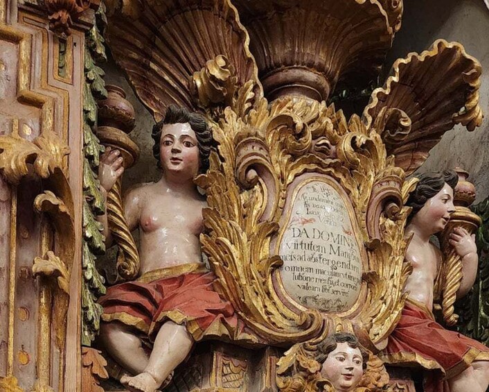 A detailed religious statue with ornate carvings and inscriptions. 2