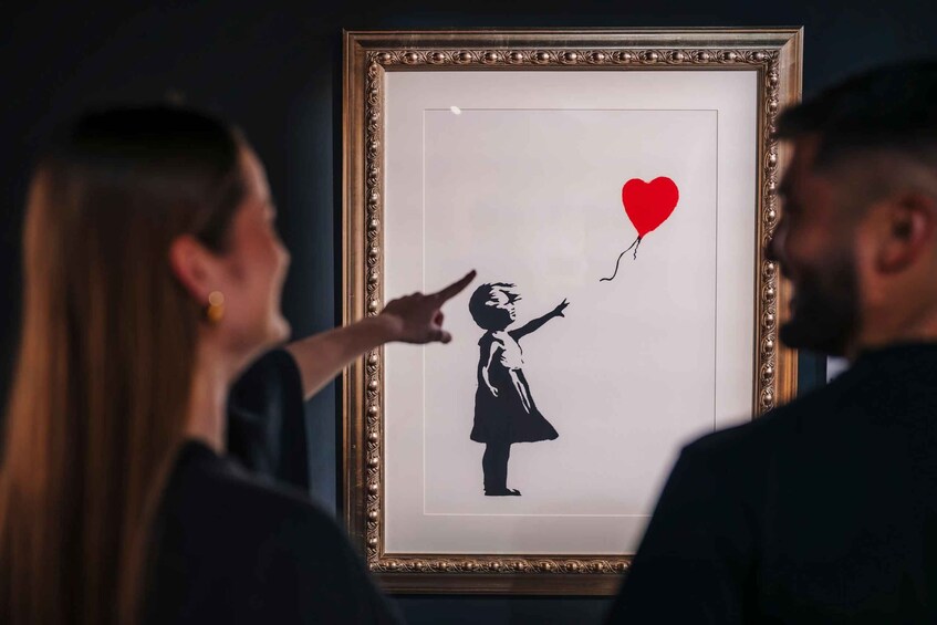 A framed artwork of a girl holding a heart-shaped balloon. 1