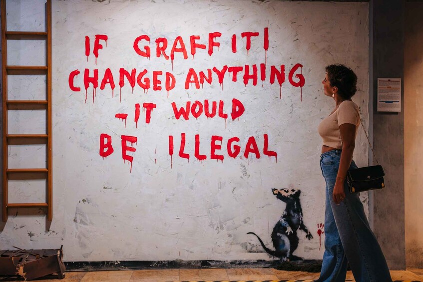 A graffiti wall with a quote and a monkey illustration. 3