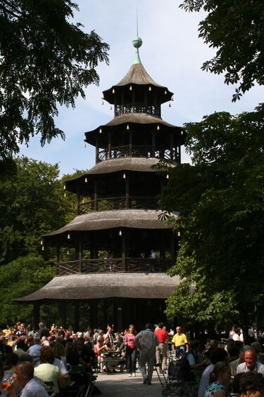 A multi-tiered pagoda-style structure surrounded by a crowd of people. 3