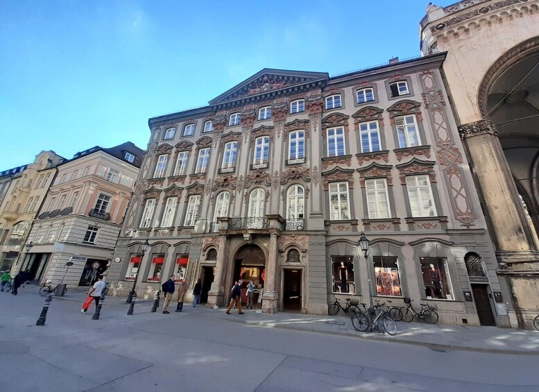 A historic building with ornate architecture, a central entrance, and a bicycle parked outside. 5