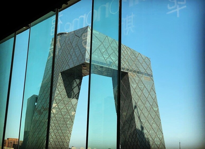 A modern glass building with a distinctive angular design. 2