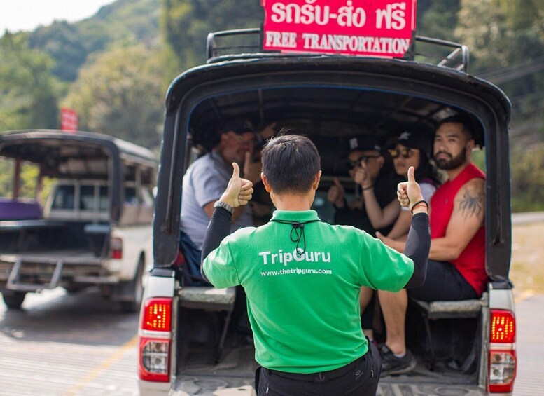 A tuk-tuk with a sign for free transportation and a TripGuru branded shirt on the driver. 5