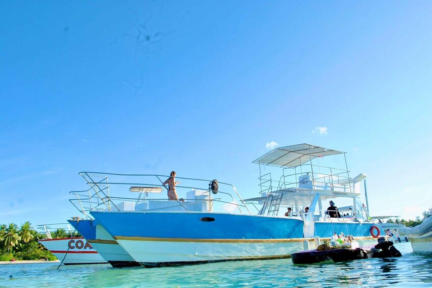 A blue and white boat with 'COA' on its side docked at a pier. 4