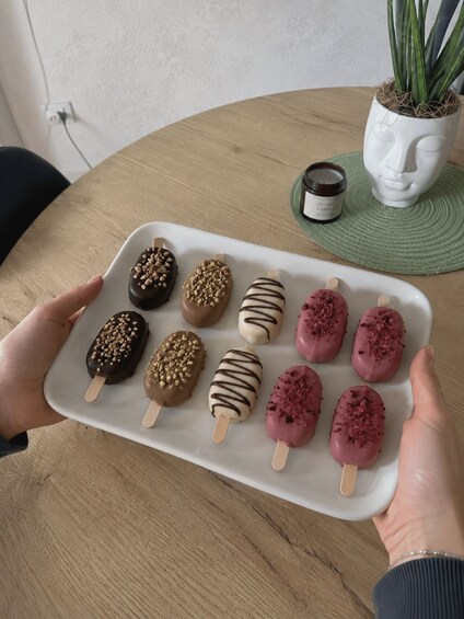 A tray of assorted chocolate-covered treats on a white plate. 2