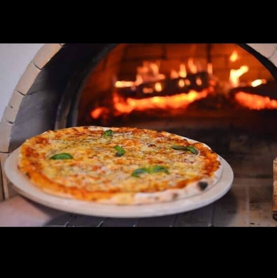 A pizza inside a brick oven. 1