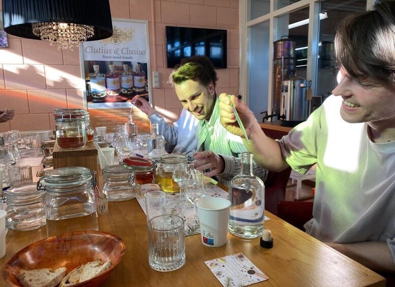 A tasting event with various beverages and food items on a wooden table. 1