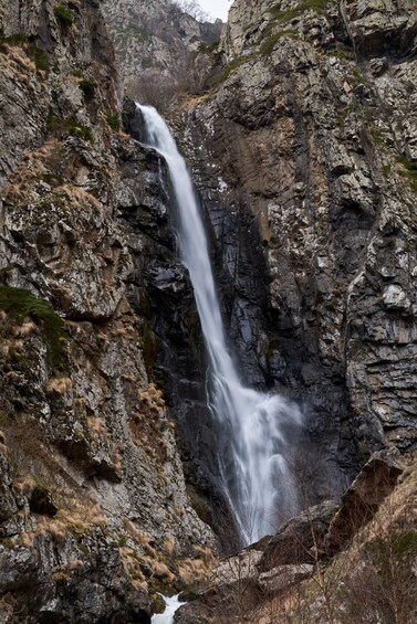 A waterfall cascading down a rocky cliff. 4